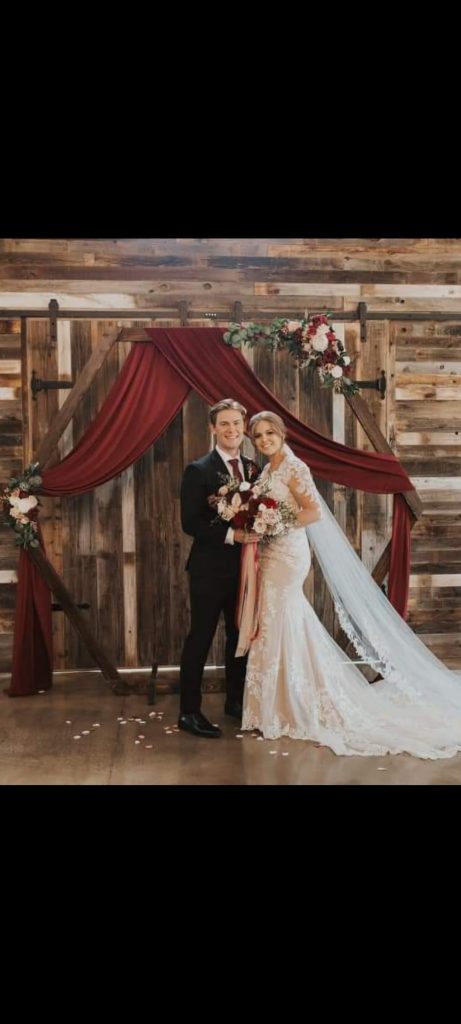 Christmas-wedding, high-end-event-space, industrial-chic-ballroom, grand-chandelier-lighting, luxury-wedding-reception, bride-and-groom, bahbees-barn-wedding